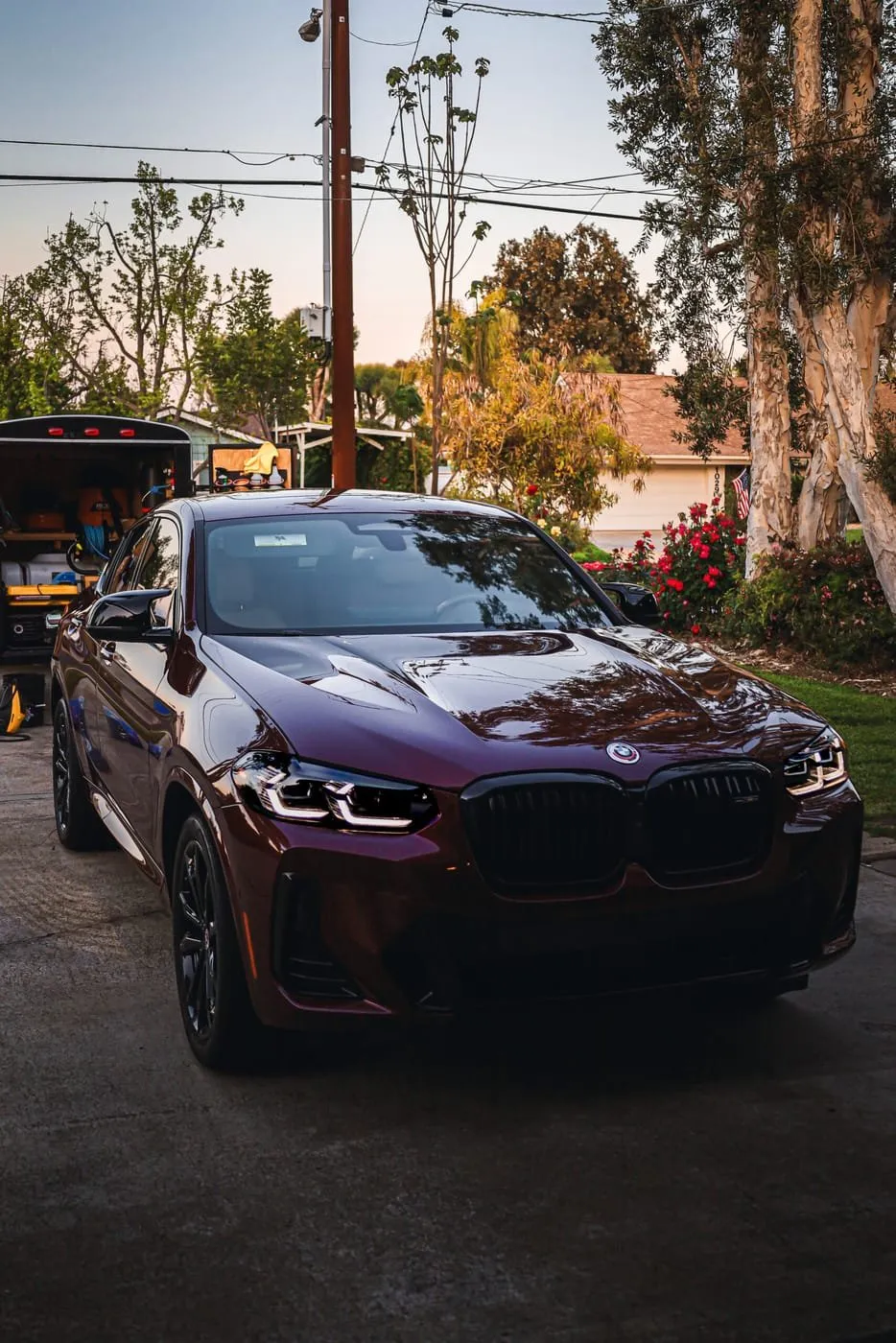 Joji's Mobile Detailing service truck and a red BMW