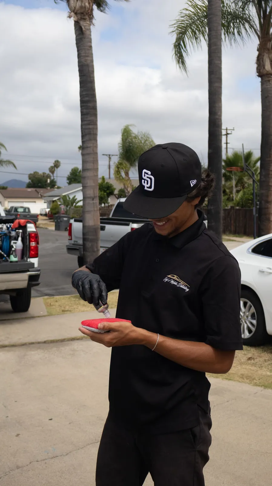 Technician applying ceramic coating product in Alpine, CA, Joji's Mobile Detailing