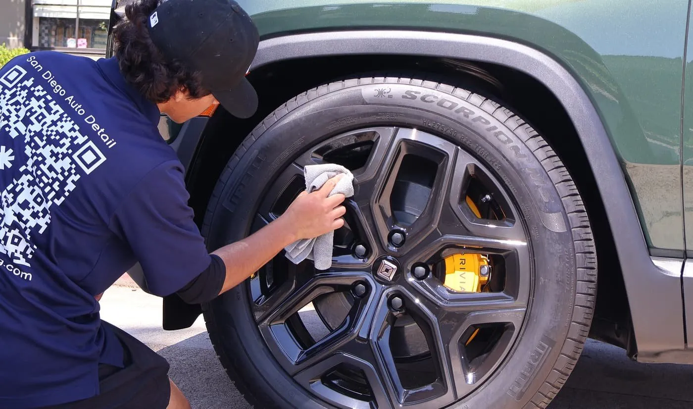 Technician detailing a wheel in Santee, CA, Joji's Mobile Detailing